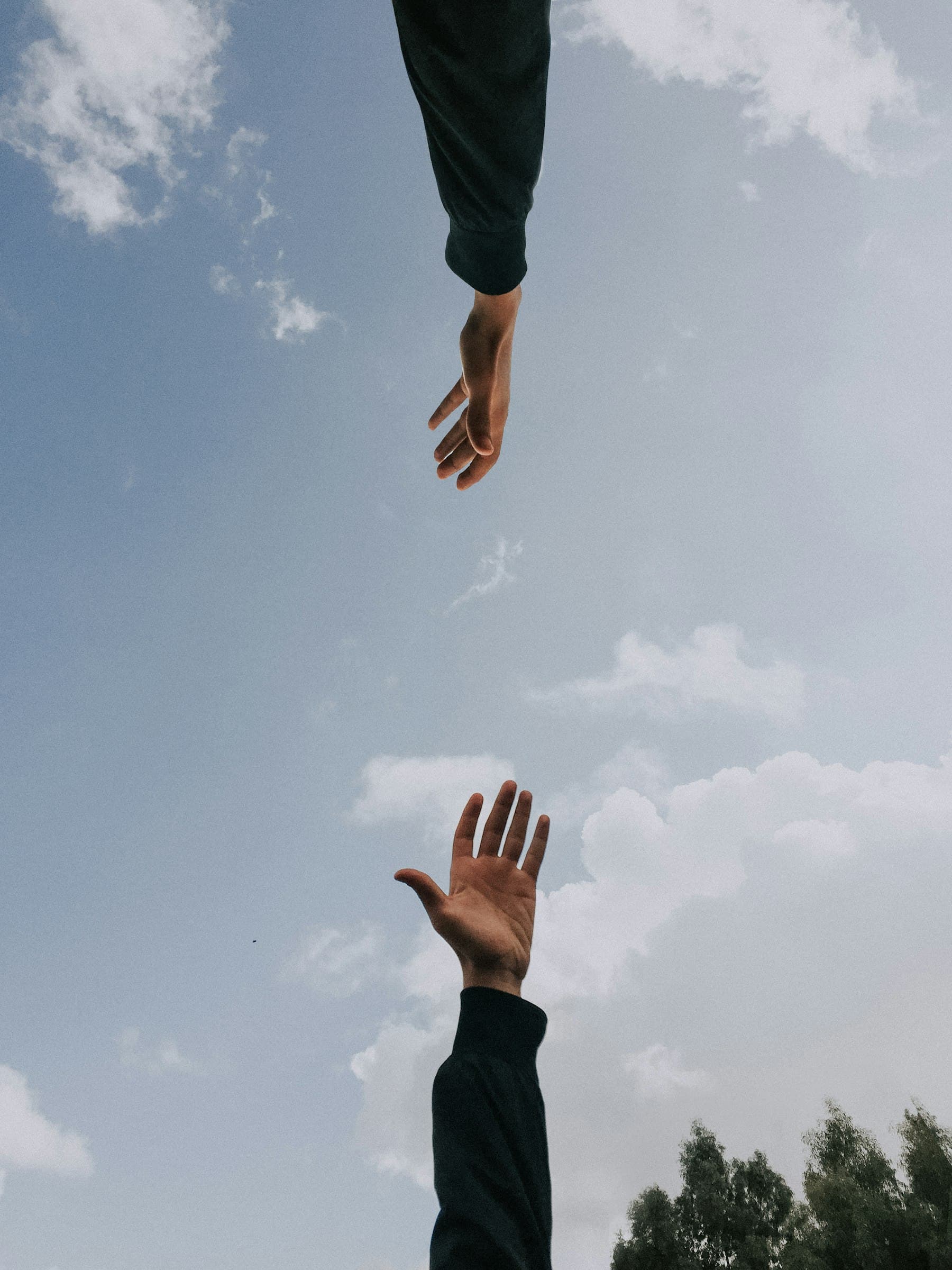 Two people holding each other's arms in a quiet moment