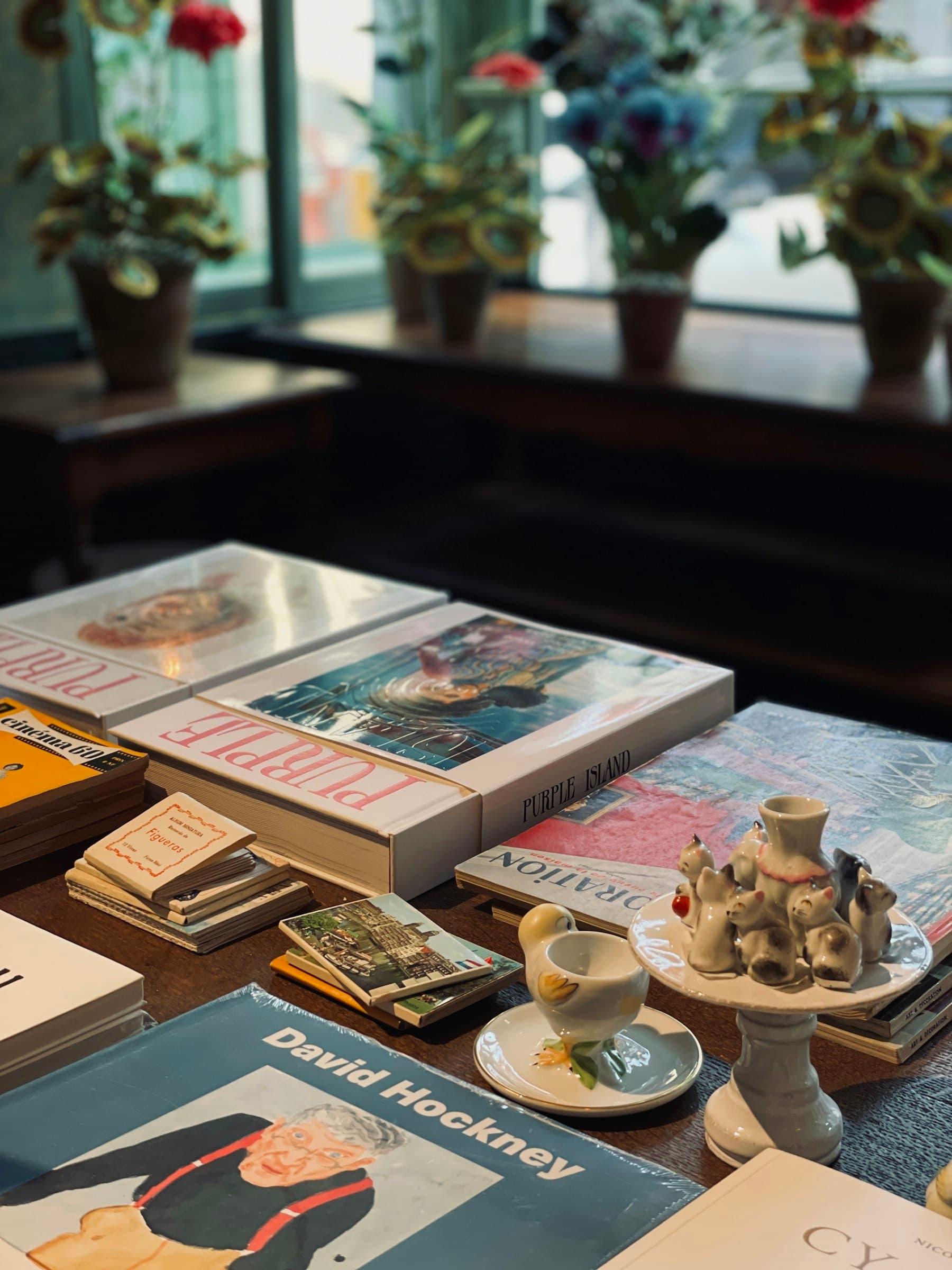 Stack of books near a window with warm natural light